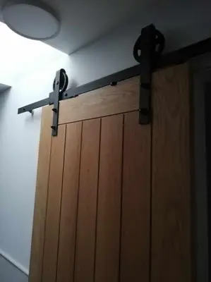 a wooden door with black hinges and a ceiling at Borrowmoss Bothy, Charming & Characterful property, Wigtown in Wigtown