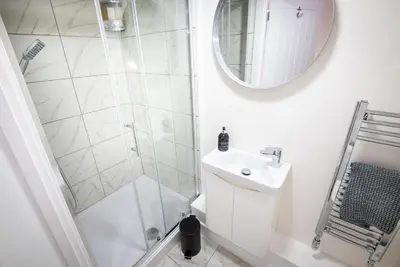 a white bathroom with a shower and a sink at Kings Arms Suites - Deluxe Room - En-Suite - Self Check In in Whitehaven