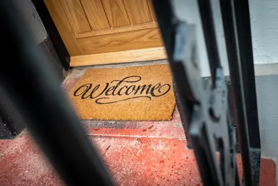 a door with the word welcome written on a door mat at Kings Arms Suites - Deluxe Room - En-Suite - Self Check In in Whitehaven