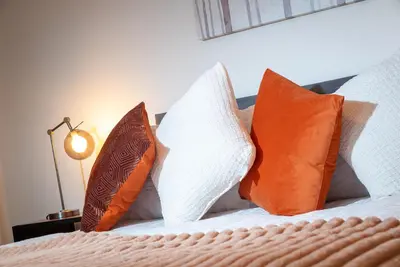 four pillows sitting on top of a bed at Kings Arms Suites - Luxury Double - Waterfall Shower - Self Check In in Whitehaven