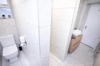 a white bathroom with a toilet and a sink at Kings Arms Suites - Luxury Double - Waterfall Shower - Self Check In in Whitehaven