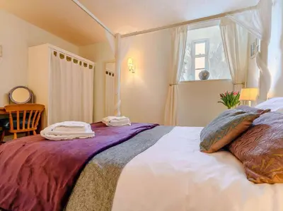 a bedroom with a large bed with pillows and a window at 3 Bed in Watermillock SZ318 in Watermillock