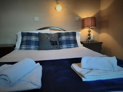 a bedroom with a bed with towels on it at The Imperial Hotel in Castle Douglas