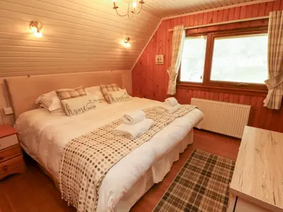 a bedroom with a large bed in a room at Thistle Dubh 