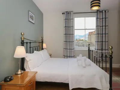 a bedroom with a bed and a window at Baystones in Keswick