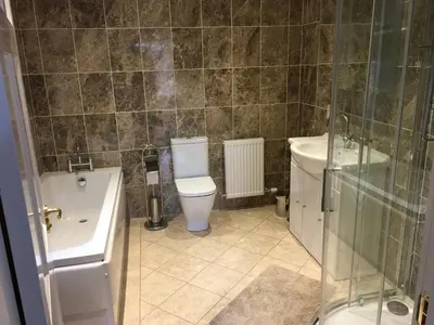 a bathroom with a toilet and a sink and a shower at Cottage in Ayr