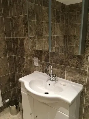 a bathroom with a sink and a mirror at Cottage in Ayr