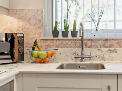 a kitchen counter with a sink and a bowl of fruit at 1 Bed in Bassenthwaite 91211 in Bassenthwaite Lake