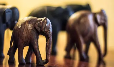 a wooden toy elephant standing on a wooden table at Clonyard House Hotel in Dalbeattie