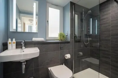 a bathroom with a sink and a toilet and a shower at Serene Retreat in Chapel Stile by LetMeStay in Ambleside