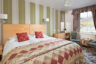 a bedroom with a bed and a desk and a chair at Burleigh Mead in Keswick