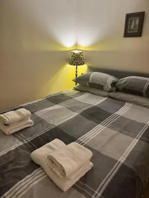 a bed with two towels on top of it at Doddick Bothy in Threlkeld