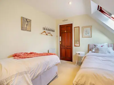 a bedroom with two beds and a staircase at 4 Bed in Crosby-on-Eden 94398 in Crosby