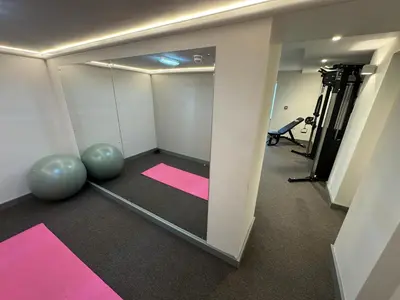 a room with a mirror and a gym with pink mats at Grindal Studio Apartments - Newly Opened Luxury Accommodation in St Bees