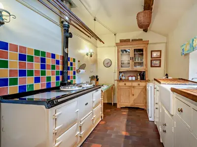 a large kitchen with colorful tiles on the wall at 3 Bed in Eskdale 94529 in Eskdale