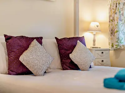 a bed with two pillows on top of it at 1 Bed in Eskdale 94530 in Eskdale