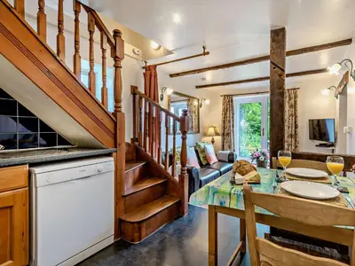 a kitchen and living room with a table and a stairway at 1 Bed in Eskdale 94530 in Eskdale