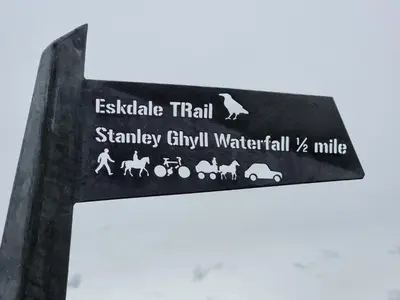 a sign for a train station with animals on it at 1 Bed in Eskdale 94530 in Eskdale