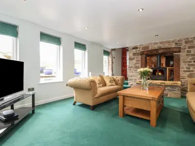 a living room with a couch and a tv at The Gardener's Bothy in Penrith