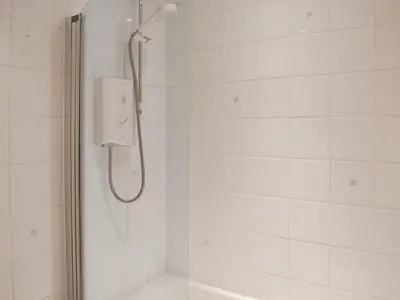 a shower with a shower head in a bathroom at Grisedale View - Hewetson Court in Keswick