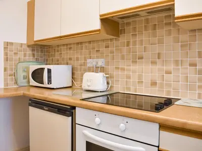 a kitchen with a sink and a microwave on a counter at Grisedale View - Hewetson Court in Keswick
