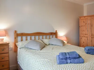 a bedroom with a bed with two towels on it at Grisedale View - Hewetson Court in Keswick