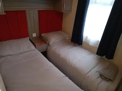 two beds in a small room with a window at Green Dream in Cockermouth
