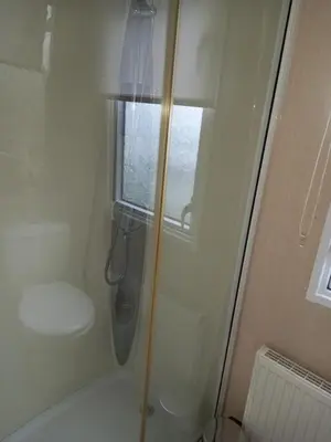 a shower with a window and a toilet in a bathroom at Green Dream in Cockermouth