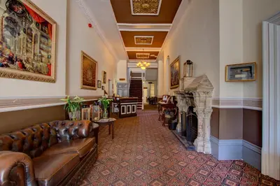 a living room with a couch and a fireplace at The Ennerdale Country House Hotel ‘A Bespoke Hotel’ in Cleator