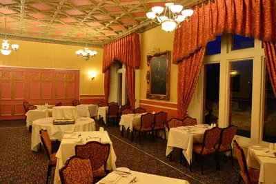 a dining room with white tables and chairs at The Ennerdale Country House Hotel ‘A Bespoke Hotel’ in Cleator