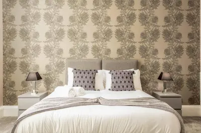 a bedroom with a large bed with two lamps at South Beach View in Troon