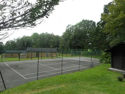 a tennis court with two tennis courts at Birch Lodge in Newton Stewart