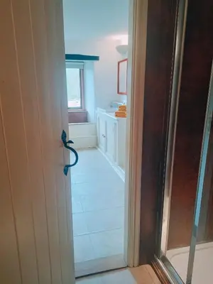 an open door to a kitchen with a bathroom at The Duddon Nest in Ulpha