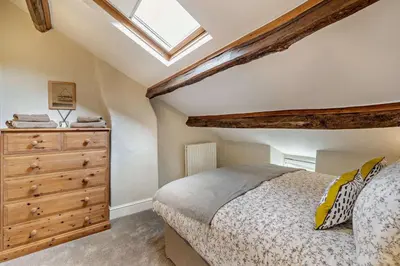 a bedroom with a bed and a wooden dresser at 4 Bed in Kinniside oc-c28854 in Frizington