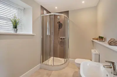 a bathroom with a shower and a toilet and a sink at 4 Bed in Kinniside oc-c28854 in Frizington