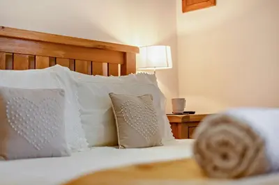 a bed with white pillows and a wooden headboard at 1 Bed in Irthington oc-t28309 in Irthington