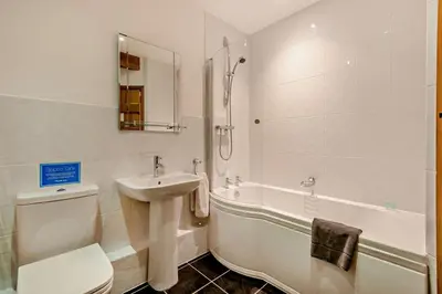 a bathroom with a sink and a toilet and a tub at 1 Bed in Irthington oc-t28309 in Irthington