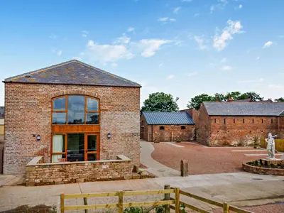 a brick building with a large window on it at 2 Bed in Irthington oc-v28308 in Irthington