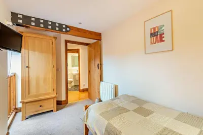 a bedroom with a bed and a flat screen tv at 2 Bed in Irthington oc-m28305 in Irthington