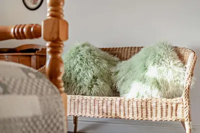 a wicker basket with faux fur cushions in it at 3 Bed in Bowness-on-Solway oc-p28797 in Bowness-on-Solway