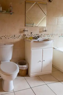a bathroom with a toilet and a sink and a tub at Kipplochan in Dalbeattie