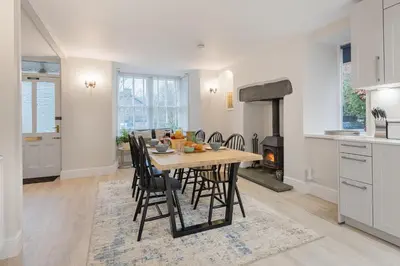 a kitchen and dining room with a table and chairs at Rockwood- Grasmere family cottage with Hot tub in Grasmere