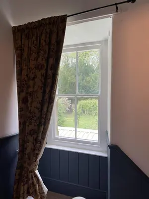 a window with a curtain in a room at Stunning 2-bedroomed Cottage in Cockermouth