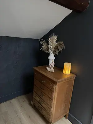 a vase on a dresser with a candle on it at Stunning 2-bedroomed Cottage in Cockermouth