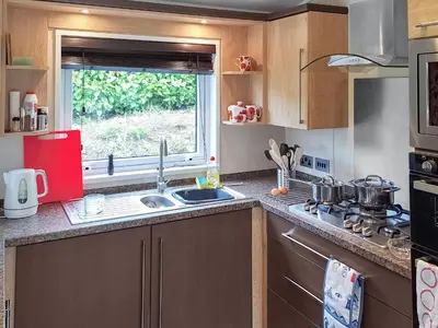 a small kitchen with a sink and a window at Forrest Lodge in Plumbland