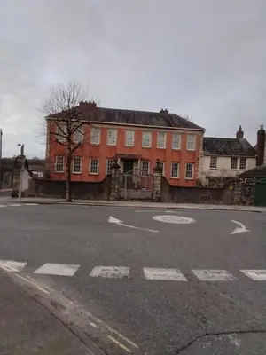 an empty street in front of a red brick building at Tanners Cottage in Cockermouth