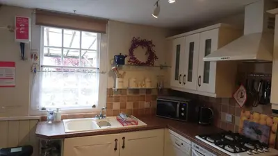 a kitchen with a sink and a window at Tanners Cottage in Cockermouth