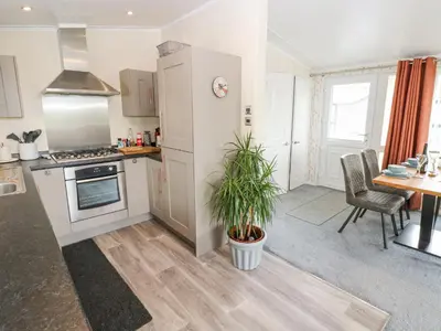 a kitchen and dining room with a table and chairs at Plot 32 in Carlisle