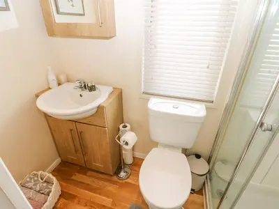 a bathroom with a toilet and a sink at Plot 32 in Carlisle