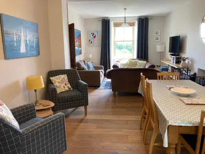 a living room with couches and a table and chairs at Laurel Bank House in Penrith